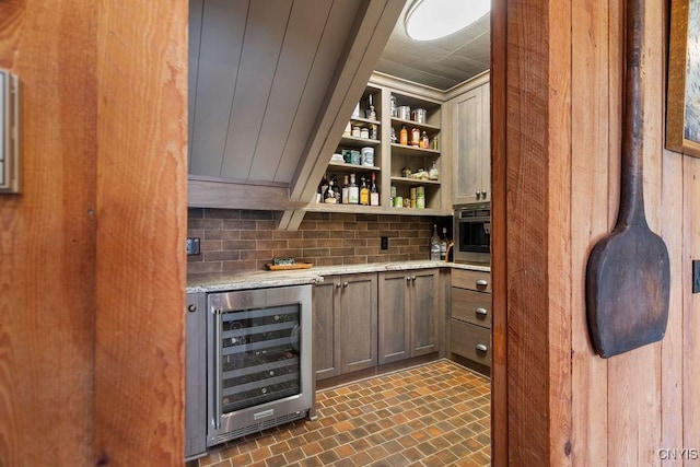 bar featuring brick floor, decorative backsplash, and wine cooler