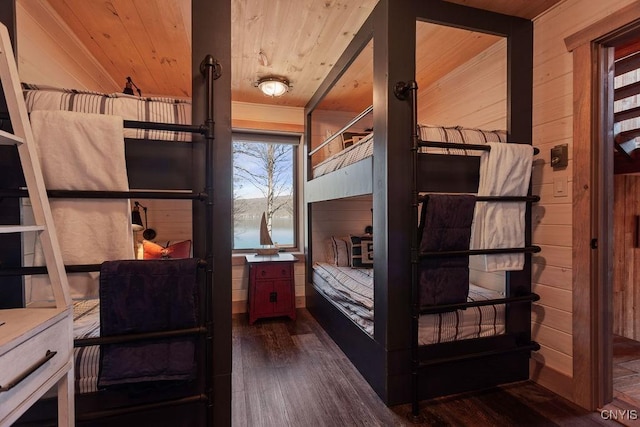 bedroom featuring wood finished floors, wood walls, and wooden ceiling