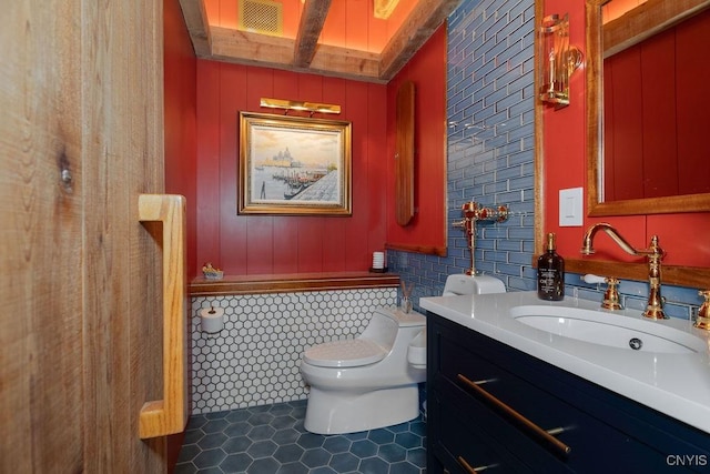 bathroom with tile patterned floors, visible vents, beam ceiling, toilet, and vanity