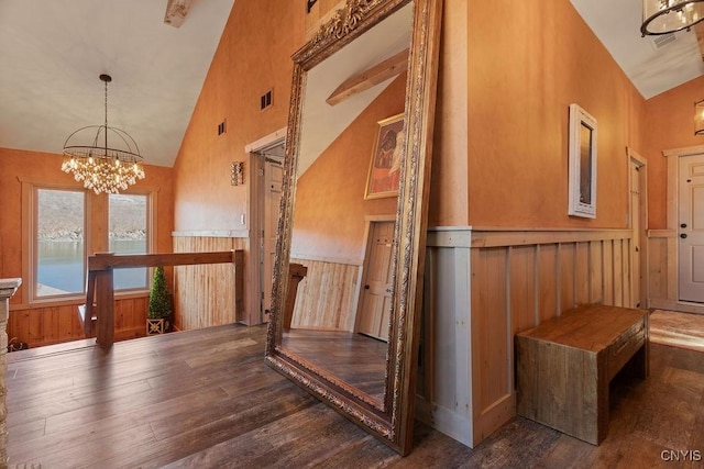 interior space with visible vents, high vaulted ceiling, hardwood / wood-style flooring, wainscoting, and a chandelier