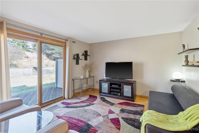 living area featuring baseboards