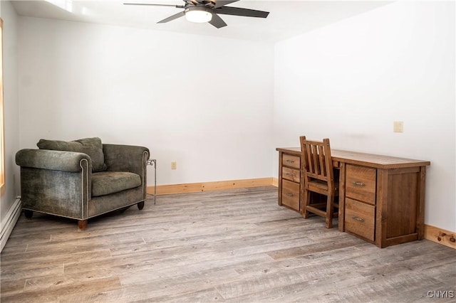 office space featuring baseboards, wood finished floors, and a ceiling fan