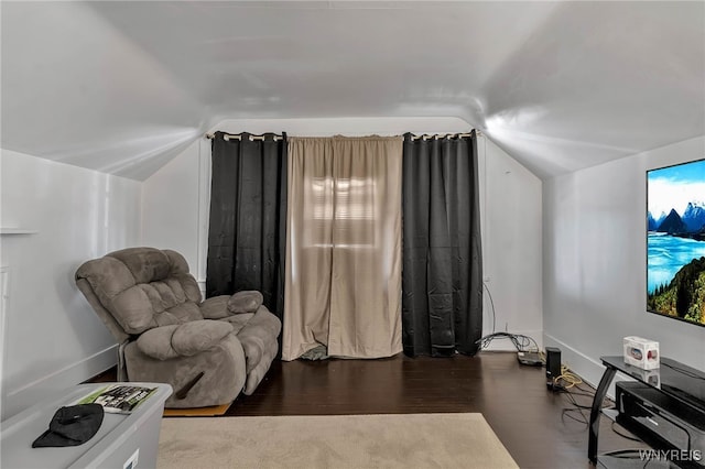 sitting room featuring lofted ceiling, wood finished floors, and baseboards