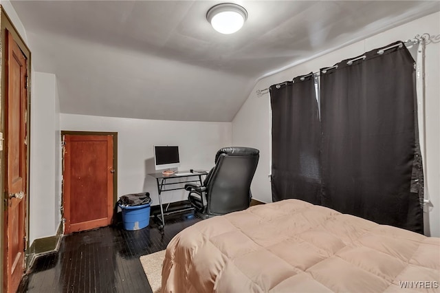 bedroom featuring dark wood-type flooring and lofted ceiling