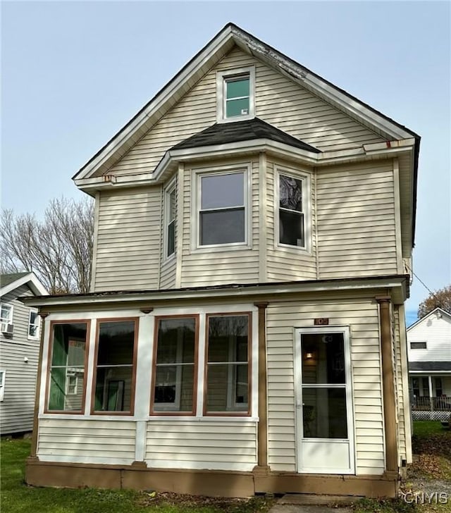 back of property with a sunroom