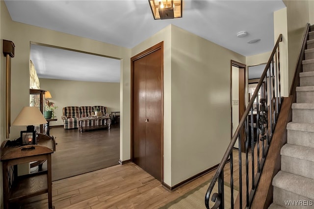 stairway featuring baseboards and wood finished floors