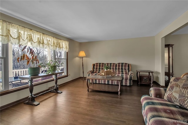 interior space with baseboards and wood finished floors