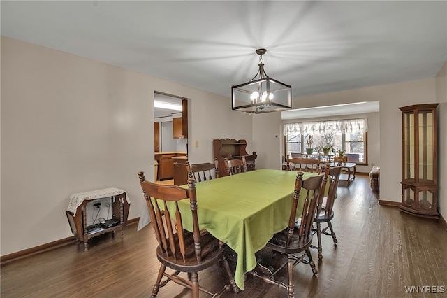 dining room with an inviting chandelier, wood finished floors, and baseboards