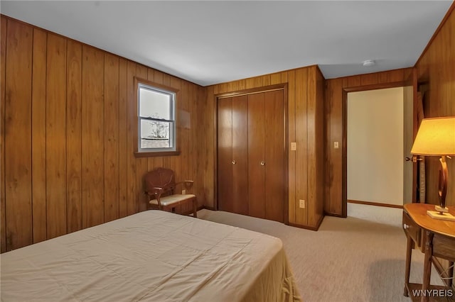 carpeted bedroom featuring a closet and wood walls