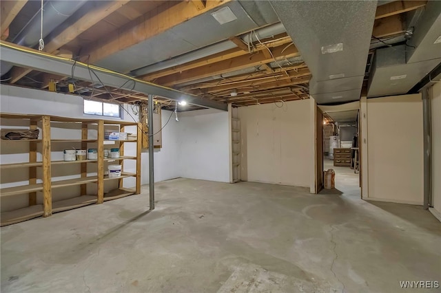 basement with electric panel and water heater