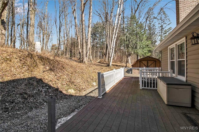 deck with an outdoor structure and a shed