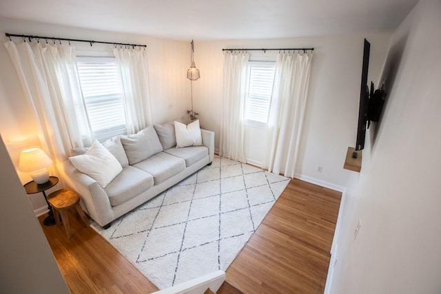 living area featuring wood finished floors and baseboards