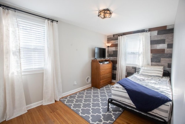 bedroom with wood finished floors and baseboards