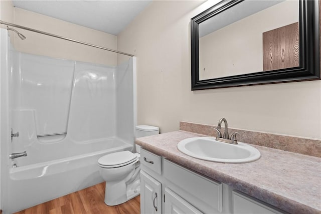 bathroom featuring vanity,  shower combination, toilet, and wood finished floors