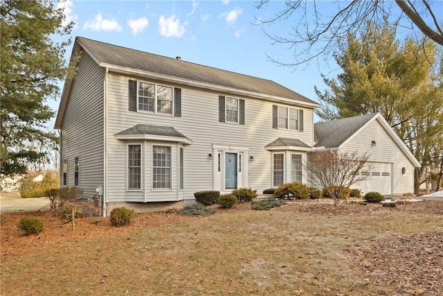 colonial inspired home featuring an attached garage