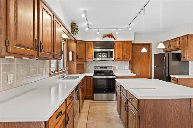 kitchen featuring a center island, brown cabinetry, appliances with stainless steel finishes, and a sink