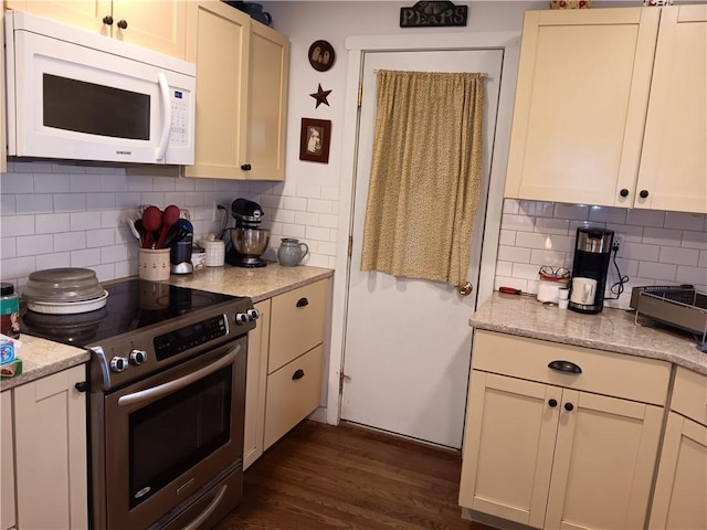 118 Roosevelt Ave, Roxbury, NY 12474 - kitchen featuring white microwave, stainless steel electric range, tasteful backsplash, dark wood-style floors, and light stone countertops