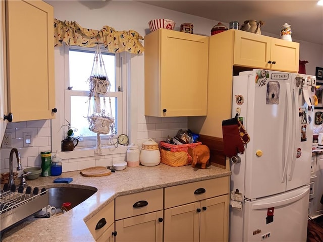 118 Roosevelt Ave, Roxbury, NY 12474 - kitchen featuring freestanding refrigerator, a sink, backsplash, and light stone counters