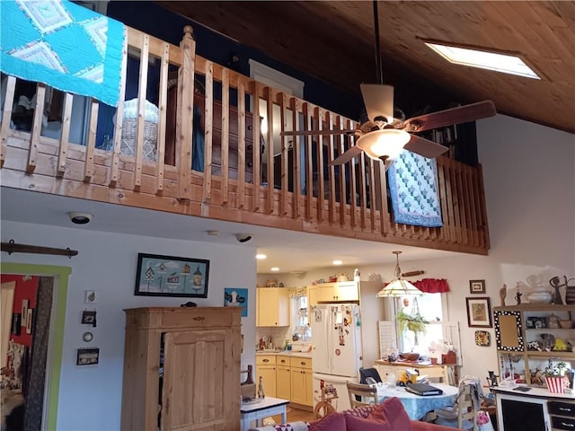 interior space featuring freestanding refrigerator and ceiling fan