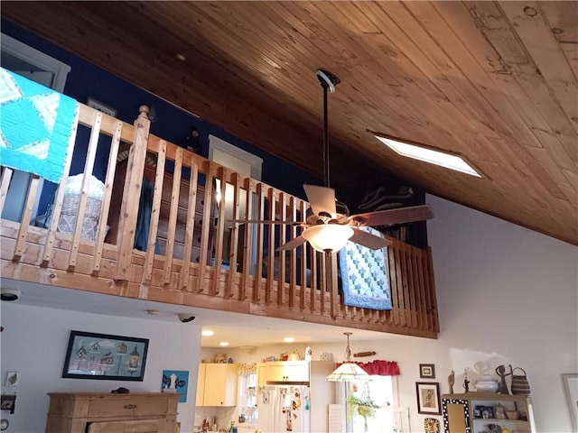 room details featuring wood ceiling, freestanding refrigerator, and a ceiling fan