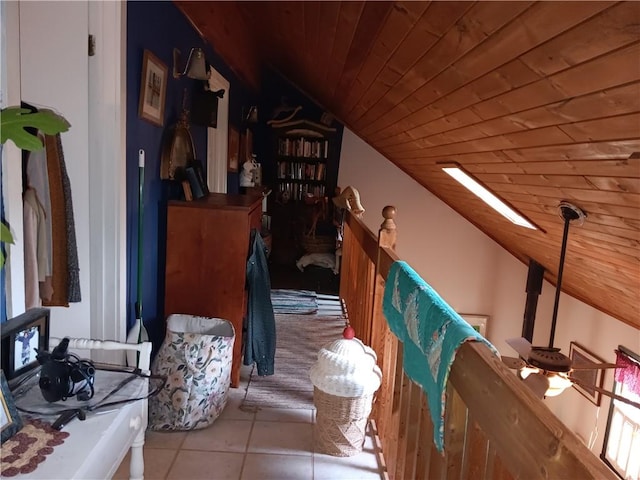 stairway featuring lofted ceiling, tile patterned floors, and wooden ceiling