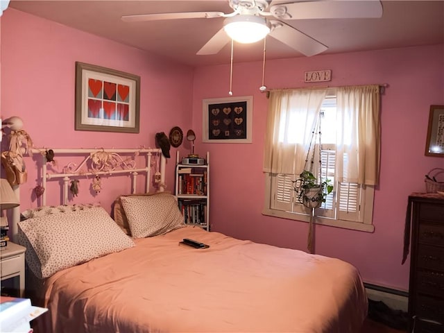 bedroom with a ceiling fan and a baseboard radiator