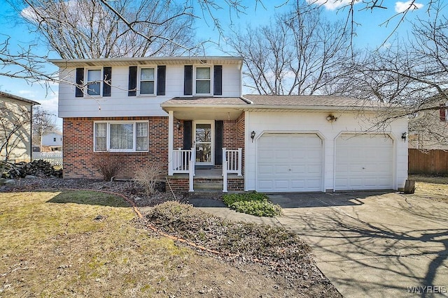 traditional-style house featuring an attached garage, fence, brick siding, and driveway