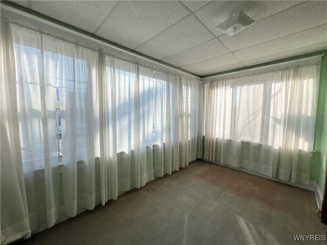 unfurnished sunroom featuring a paneled ceiling