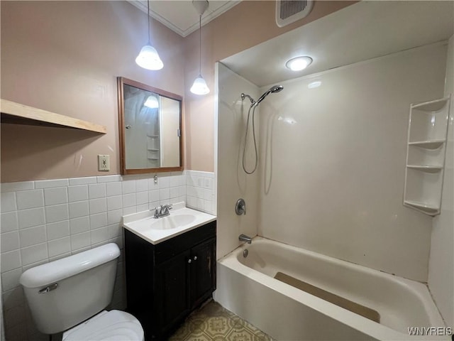 full bath with visible vents, toilet, tile walls, bathtub / shower combination, and vanity