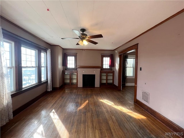 unfurnished living room featuring visible vents, a ceiling fan, hardwood / wood-style floors, crown molding, and a brick fireplace