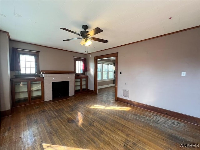 unfurnished living room with plenty of natural light, baseboards, visible vents, and wood-type flooring