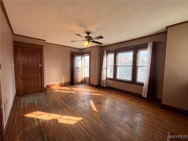 unfurnished room with hardwood / wood-style floors, baseboards, ornamental molding, and a ceiling fan