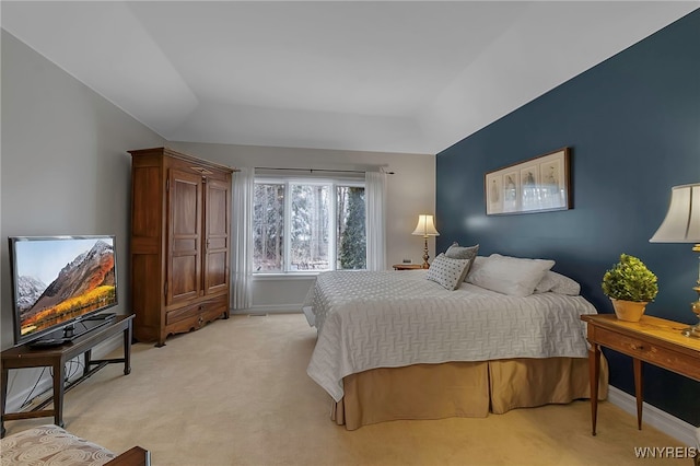 bedroom featuring light colored carpet and baseboards