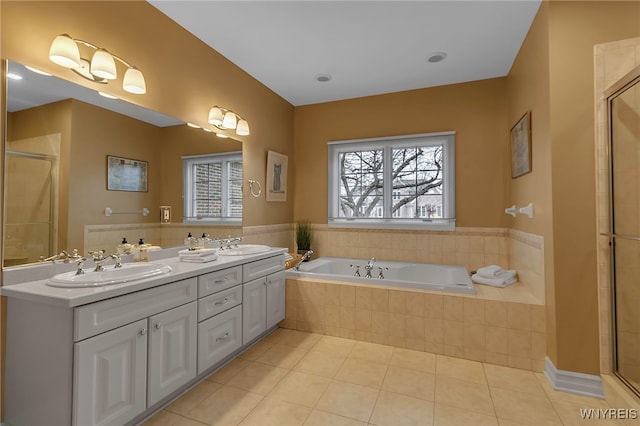 full bath featuring tile patterned floors, a bath, tiled shower, and a sink