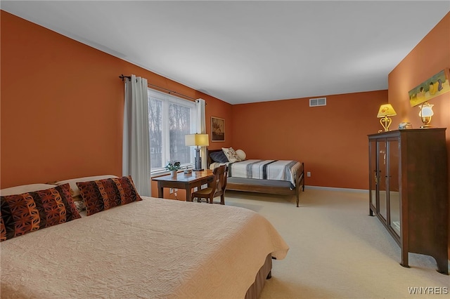 carpeted bedroom with visible vents and baseboards