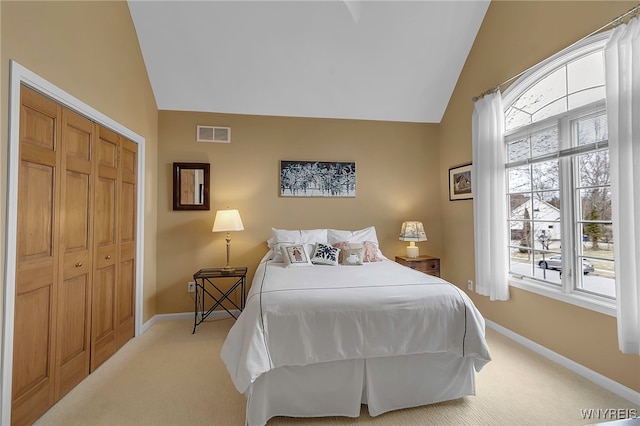 bedroom with visible vents, light colored carpet, baseboards, and lofted ceiling