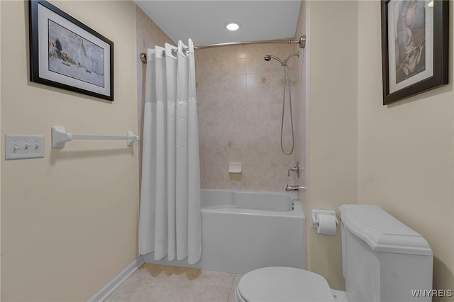 full bathroom with tile patterned floors, toilet, baseboards, and shower / bath combo with shower curtain