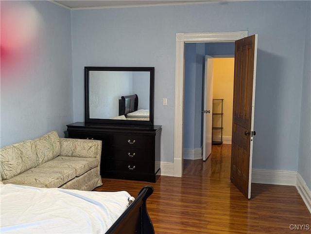 bedroom featuring dark wood-style floors and baseboards