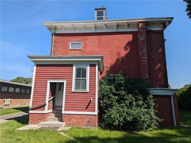 back of house with brick siding