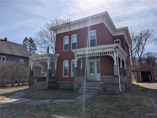 italianate-style house with a detached garage and an outdoor structure