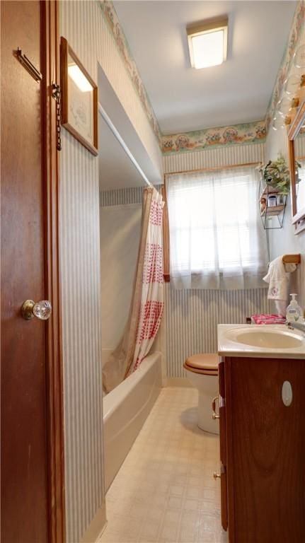 bathroom featuring vanity, wallpapered walls, shower / bath combination with curtain, tile patterned floors, and toilet