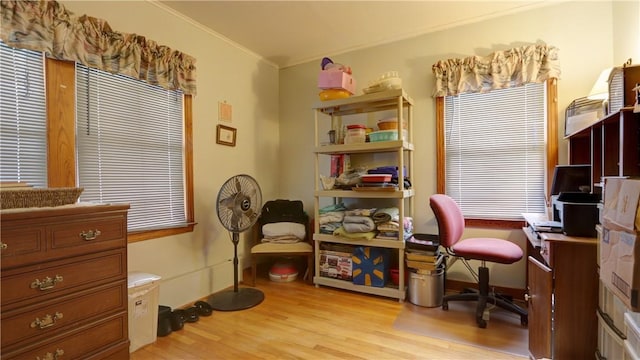 office area featuring light wood-type flooring, baseboards, and crown molding