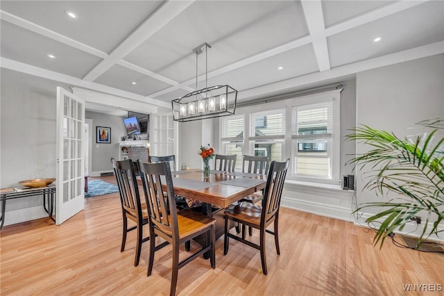 dining area featuring french doors, coffered ceiling, baseboards, and light wood finished floors