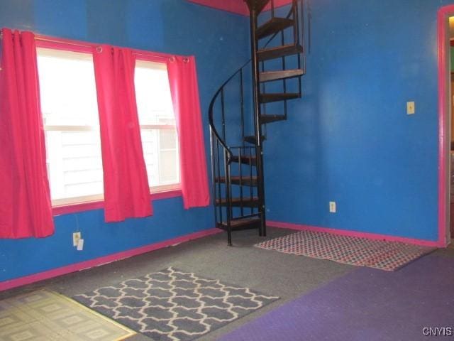 interior space featuring a wealth of natural light, stairway, and baseboards