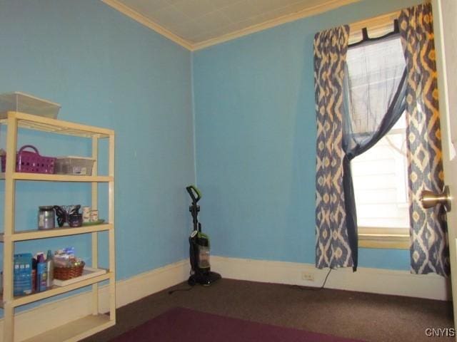 unfurnished room with baseboards, carpet floors, and crown molding