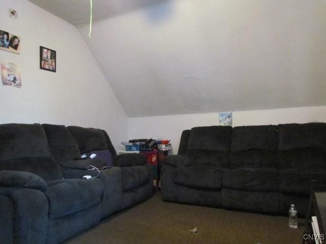 carpeted living area featuring vaulted ceiling