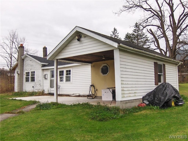 back of property featuring a patio and a yard