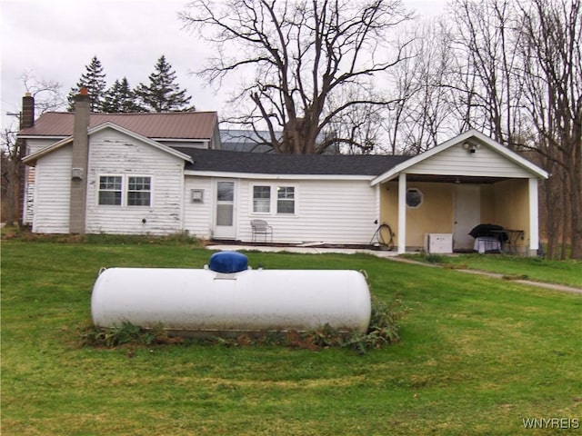 view of front of house featuring a chimney and a front lawn