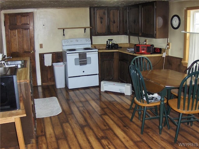 kitchen featuring a sink, dark wood finished floors, white electric range oven, light countertops, and dark brown cabinets