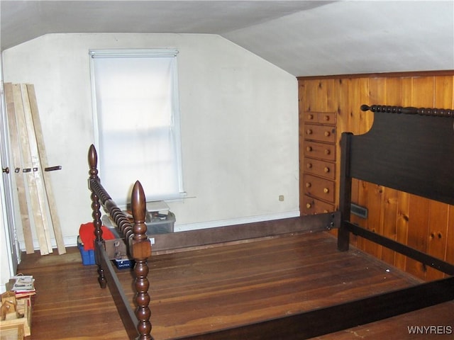 bedroom with wood finished floors and vaulted ceiling